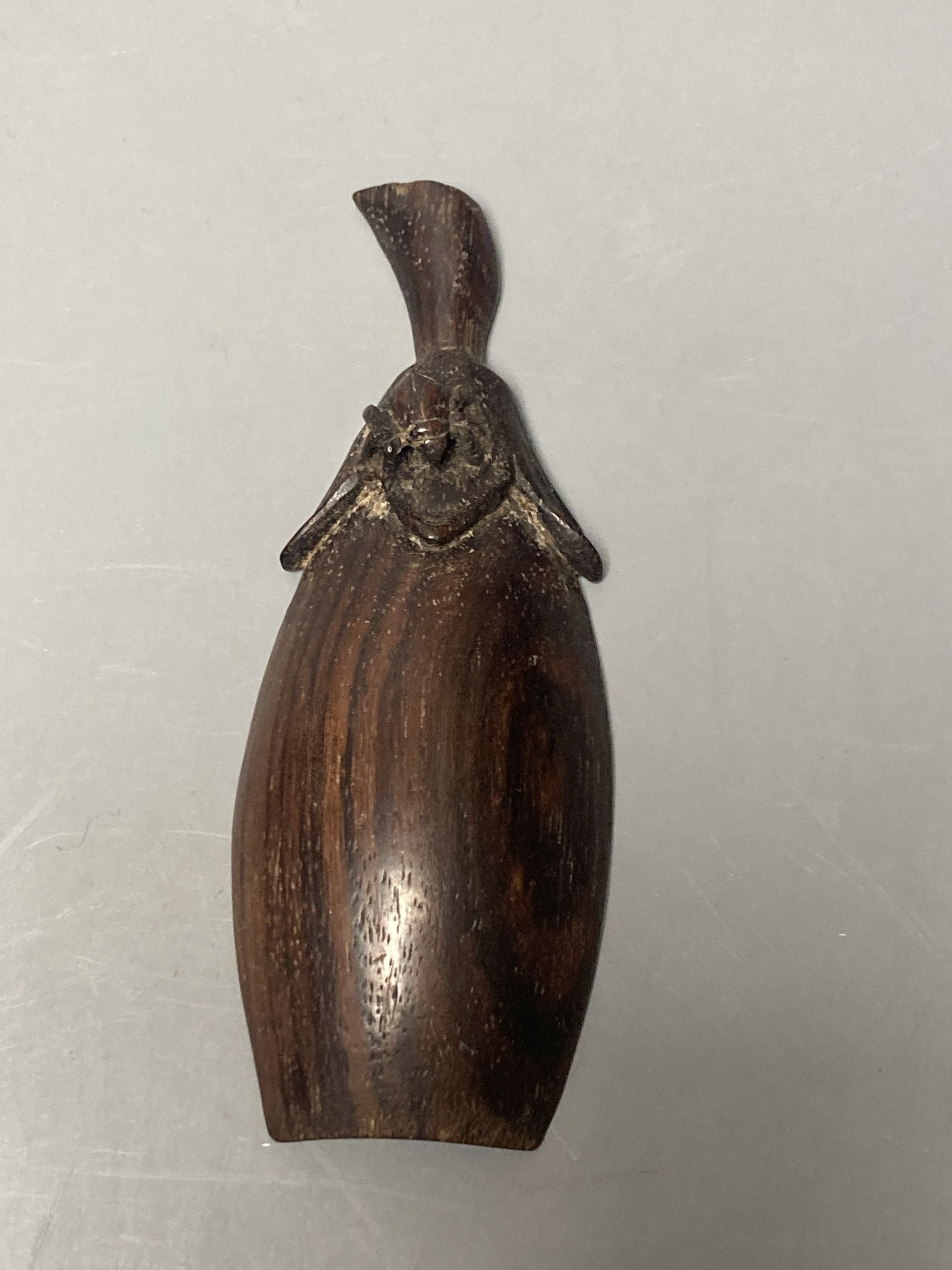 A Japanese bamboo wrist wrest, a Chinese jadeite, bamboo scoop and wooden carving possibly Zitan, 19th century etc.